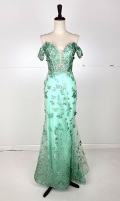 The Off-Shoulder Long Butterfly Prom Dress: Chicas C332 is shown on a dress form, featuring mint green color, a deep V-neckline, sparkling floral embellishments, and a fitted mermaid silhouette.