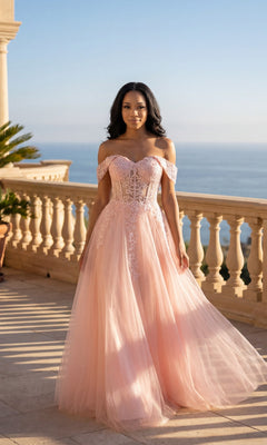 A woman in the blush Long Prom Dress: Chicas C336 stands on a sunlit balcony with a scenic ocean view in the background.