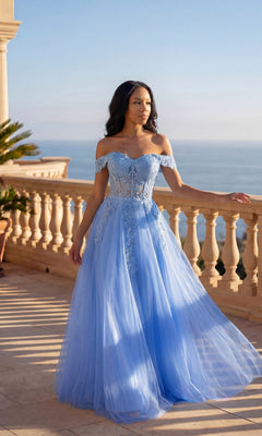 A woman stands on a sunlit terrace by the sea, wearing the Chicas C336 Long Prom Dress in perri blue—an off-the-shoulder gown with floral lace embroidery, a fitted bodice, adjustable lace-up back, and a floor-length silhouette.