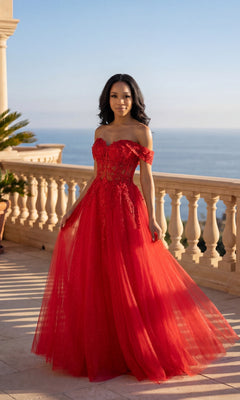 A woman stands on a terrace overlooking the ocean, wearing the Chicas C336 Long Prom Dress in red, featuring off-shoulder styling with floral lace embroidery and delicate tulle details.
