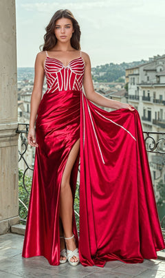 Wearing the Side Sash Long Corset Prom Dress: Chicas C343, a woman in red satin with a thigh-high slit and white bodice detailing stands gracefully on a balcony against the cityscape below.