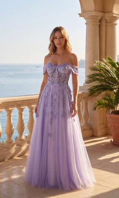 A woman stands on a terrace by the sea, wearing the Long Prom Dress: Chicas C350 in lilac, featuring an off-the-shoulder A-line silhouette with floral accents and a delicate corset-style bodice.