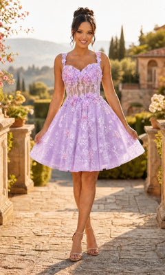 A woman stands outdoors on a stone path, smiling toward the camera as she holds the skirt of her lavender Chicas C352 short homecoming dress, which features a sleeveless fit-and-flare silhouette with delicate 3D floral appliques.