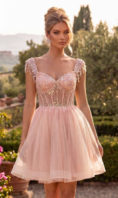 A woman stands outdoors in a garden at sunset, wearing the Chicas C356 short homecoming dress in blush—featuring a fitted, sequined bodice and a tulle fit-and-flare skirt.