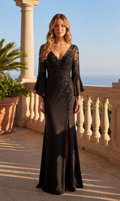 A woman in the Long Formal Dress: Chicas C357, a black gown with sheer sleeves and sequin details, stands on a sunlit terrace with balustrades and potted plants.