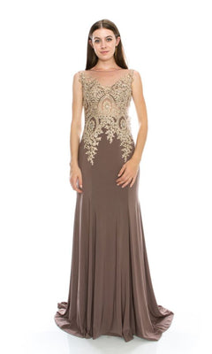 A woman stands against a plain white background, wearing the Chicas C4233 Gold-Embroidered Long Prom Dress—a sleeveless, floor-length taupe gown with intricate gold embroidery on the bodice.