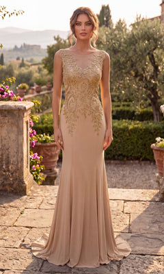 A woman stands on a stone path in a garden setting, wearing the Chicas C4233 Gold-Embroidered Long Prom Dress in taupe and gold.
