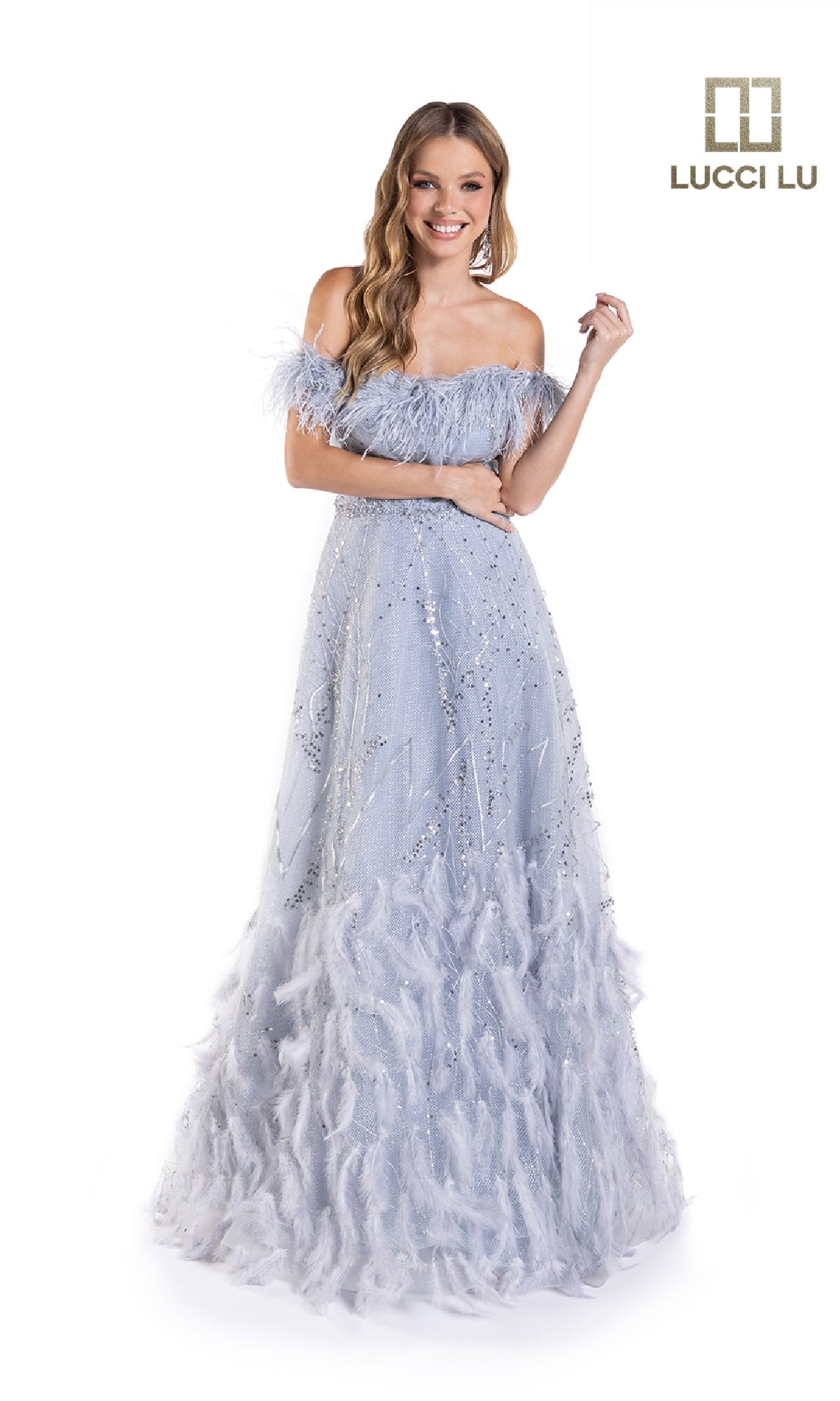 A woman smiles against a white background wearing the Lucci Lu C8052 long prom dress, a sequin-embellished light blue off-the-shoulder evening gown with feather details. The 