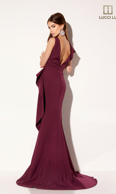 A woman poses against a white background in the Lucci Lu C8108, a sleeveless, floor-length formal dress in deep purple with an open back and elegant v-neckline. The Lucci Lu logo appears in the top right corner.