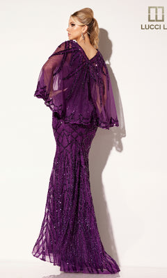 A woman models the Lucci Lu C8109 long formal dress, a fitted purple gown with beaded patterns and a sheer capelet, flowing elegantly to the floor as she faces away from the camera.