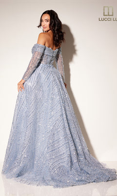 A woman poses with her back to the camera in the Lucci Lu C8112 long formal dress, featuring light blue sequins, an off-the-shoulder bodice, and long sleeves against a plain white wall.