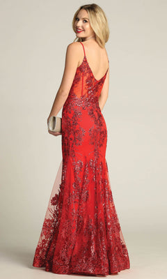 Woman in the Chicas C813 Long Glitter-Print Prom Dress, a sleeveless, floor-length mermaid gown, holds a silver clutch and glances over her shoulder against a plain background.