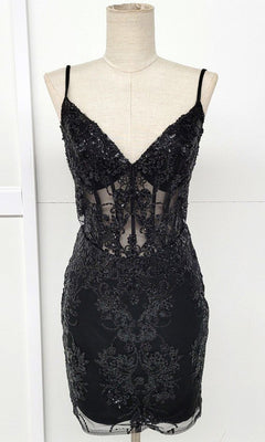 The Sheer-Corset Short Glitter Homecoming Dress C814 is a black sleeveless mini dress with thin straps, a V-neckline, and sparkling lace and sequin details—an eye-catching semi-formal look shown on a mannequin.