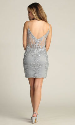 A woman faces away, wearing the Sheer-Corset Short Glitter Homecoming Dress C814 in light gray with sheer back panels, intricate lace details, and silver high heels.