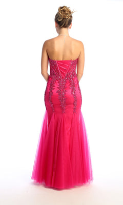 A woman faces away, wearing the Strapless Long Mermaid Prom Dress: Chicas C820 in hot pink, featuring beaded sequins, a lace-up back, and a mermaid silhouette.