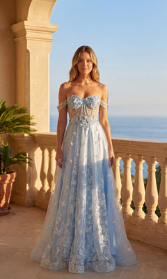 A woman in a baby blue Long Prom Dress: Chicas C822 with lace details stands on a balcony overlooking the ocean at sunset.