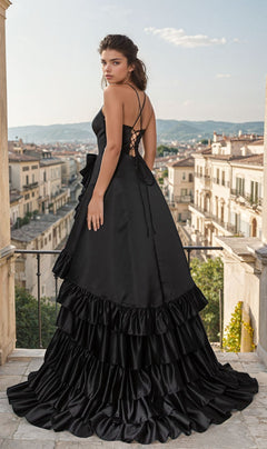 A woman in the Lace-Up Ruffled Long Prom Dress: Chicas C826 stands on a balcony, gazing over a city skyline with distant mountains.