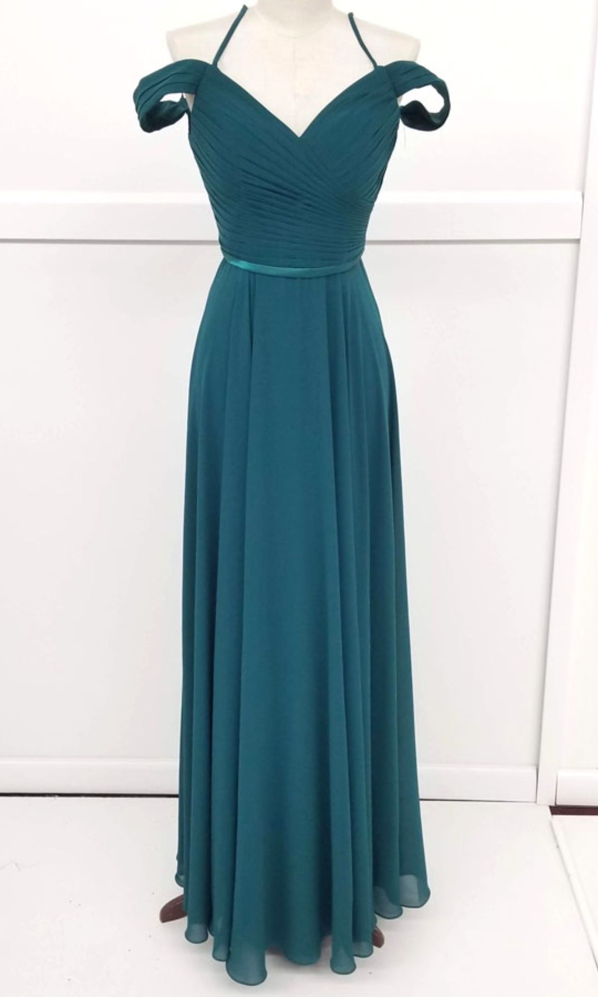 Chicas C8997 Long A-Line Off-Shoulder Prom Dress features a sweetheart neckline, ruched bodice, halter strap, and floor-length flowing skirt—displayed on a dress form against a white background for a stunning formal look.
