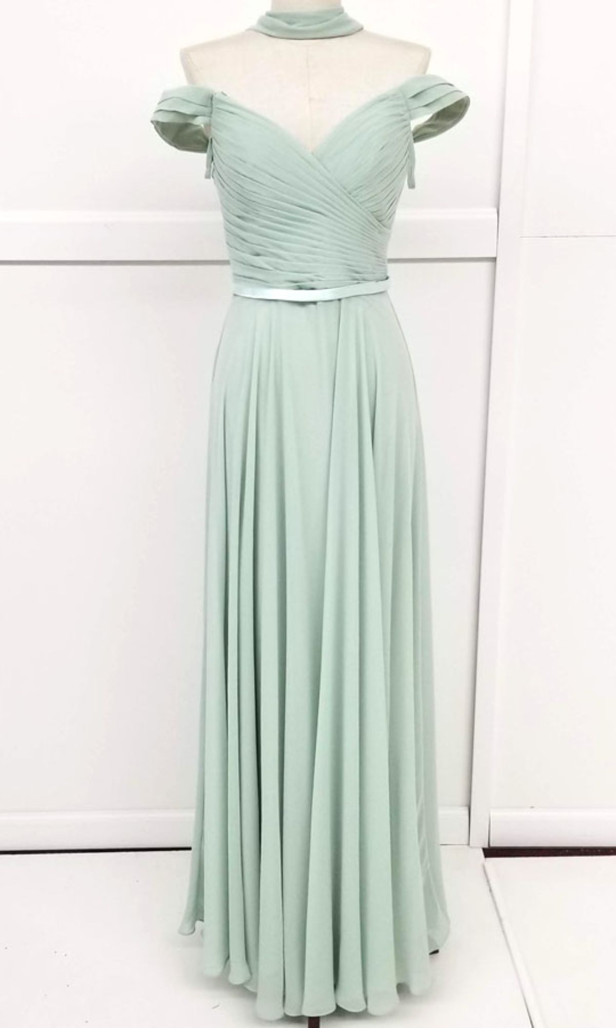 The Chicas C8997 Long A-Line Off-Shoulder Prom Dress features light green pleated bodice, draped sleeves, fitted waist, floor-length skirt, and matching choker—an elegant formal gown for any special occasion.