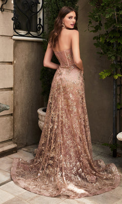 A woman stands outside in the Glitter-Print Strapless Corset Prom Dress CB046, featuring a sheer gold-embroidered overlay and subtle glitter-print details, looking over her shoulder.