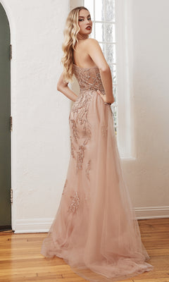 A woman stands indoors wearing the One-Shoulder Rose Gold Long Formal Gown CB098, its glittering fabric catching the light as she looks over her shoulder.