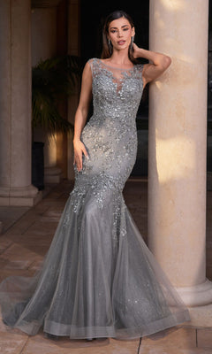 A woman in the Ladivine Long Formal Dress CB128, a silver-grey floor-length fitted mermaid gown with floral embellishments and sheer details, stands beside a stone column.