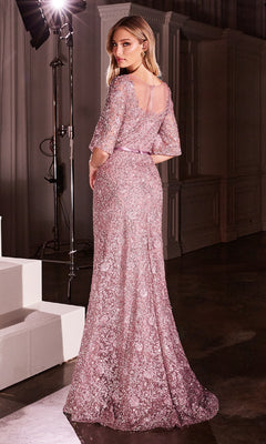 A woman stands on a dark set in the Bell-Sleeve Long Glitter Prom Dress: Ladivine CB149, a floor-length shimmering evening gown with pink floral lace and sheer bell sleeves, looking over her shoulder toward the camera.