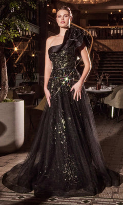 Indoors, a woman wears the Ladivine CB157 One-Shoulder Long Black Prom Dress, featuring sparkling accents and a dramatic shoulder bow.