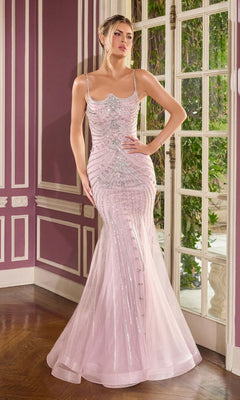 A woman in the Ladivine CB167, a fitted light pink prom dress with thin straps and beaded embellishments, stands indoors near tall windows and purple paneled walls.