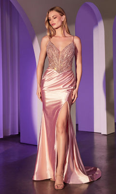 A woman poses in the Beaded-Bodice Long Prom Dress Ladivine CC0238—a blush pink, v-neck gown with thin straps, pearlized beading on the bodice, and a high slit—against a purple-lit backdrop with graceful archways.
