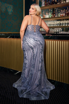 A woman in a Plus-Size Long Beaded Prom Dress: Ladivine CC0389C with a lace-up back stands at a bar, facing away, as the sheer, beaded silver gown sparkles under the lights.