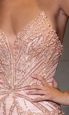 A person poses confidently in the Ladivine CC0688, a strapless long beaded prom dress with a corset bodice and blush pink color, embellished with pearls.