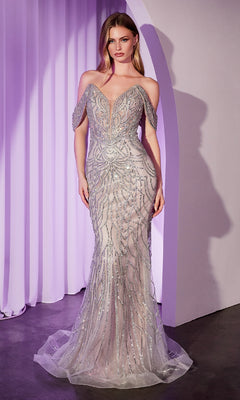 A woman stands before lavender curtains, wearing the Off-Shoulder Beaded Prom Gown: Ladivine CC0689—a silver mermaid dress adorned with beads.