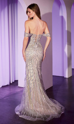 A woman stands facing away, wearing the Off-Shoulder Beaded Prom Gown: Ladivine CC0689, featuring a lace-up back and floor-length train, in a softly lit room with white arches.