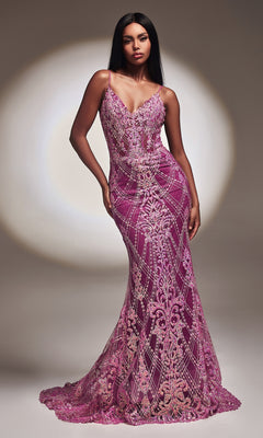 A woman poses in a studio wearing the Amethyst Long Sequin Mermaid Prom Dress CC2168, featuring intricate beading and lace details, against a neutral backdrop with a spotlight effect.