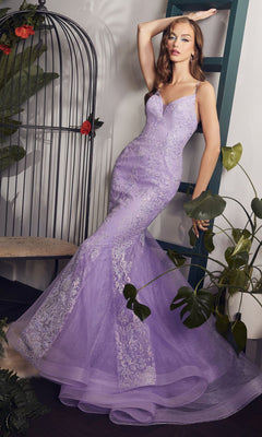 A woman poses indoors in the Strappy-Back Long Beaded Mermaid Prom Dress CC2279 near a green ladder and birdcage, surrounded by lush plants.