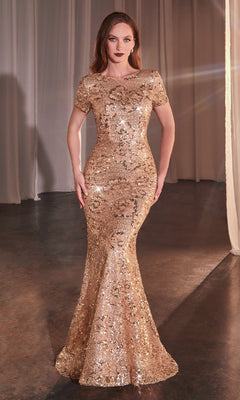 A woman stands on a dark floor wearing the Ladivine CC3700 Rose Gold Prom Dress, featuring gold sequins, short sleeves, and a flared hem. Light highlights the shimmering gown while elegant white curtains hang in the background.