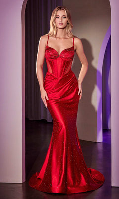 A woman stands indoors wearing the Beaded Long Mermaid Prom Dress: Ladivine CC4021, featuring thin straps, sheer panels, and sparkling embellishments—a stunning fitted evening gown.