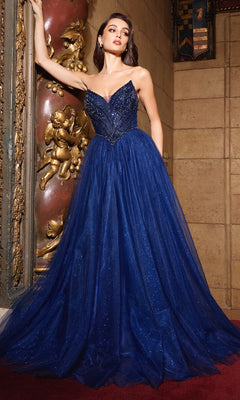 A woman wearing the Ladivine CC415 Beaded-Bodice Long Prom Dress stands indoors beside ornate gold decorations and a stone wall.