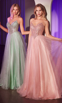 Two women stand side by side in a softly lit room, radiating elegance in the Ladivine CC415 Beaded-Bodice Long Prom Dress—one in light green and one in light pink—each showcasing the gown’s sparkling strapless a-line design.