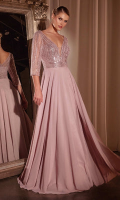 A woman stands before a mirror in the Ladivine CC446, a modest long A-line formal dress featuring a sequined bodice, sheer sleeves, and a flowing mauve skirt.