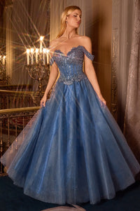 Woman in a blue glitter tulle evening gown with a chandelier in the background