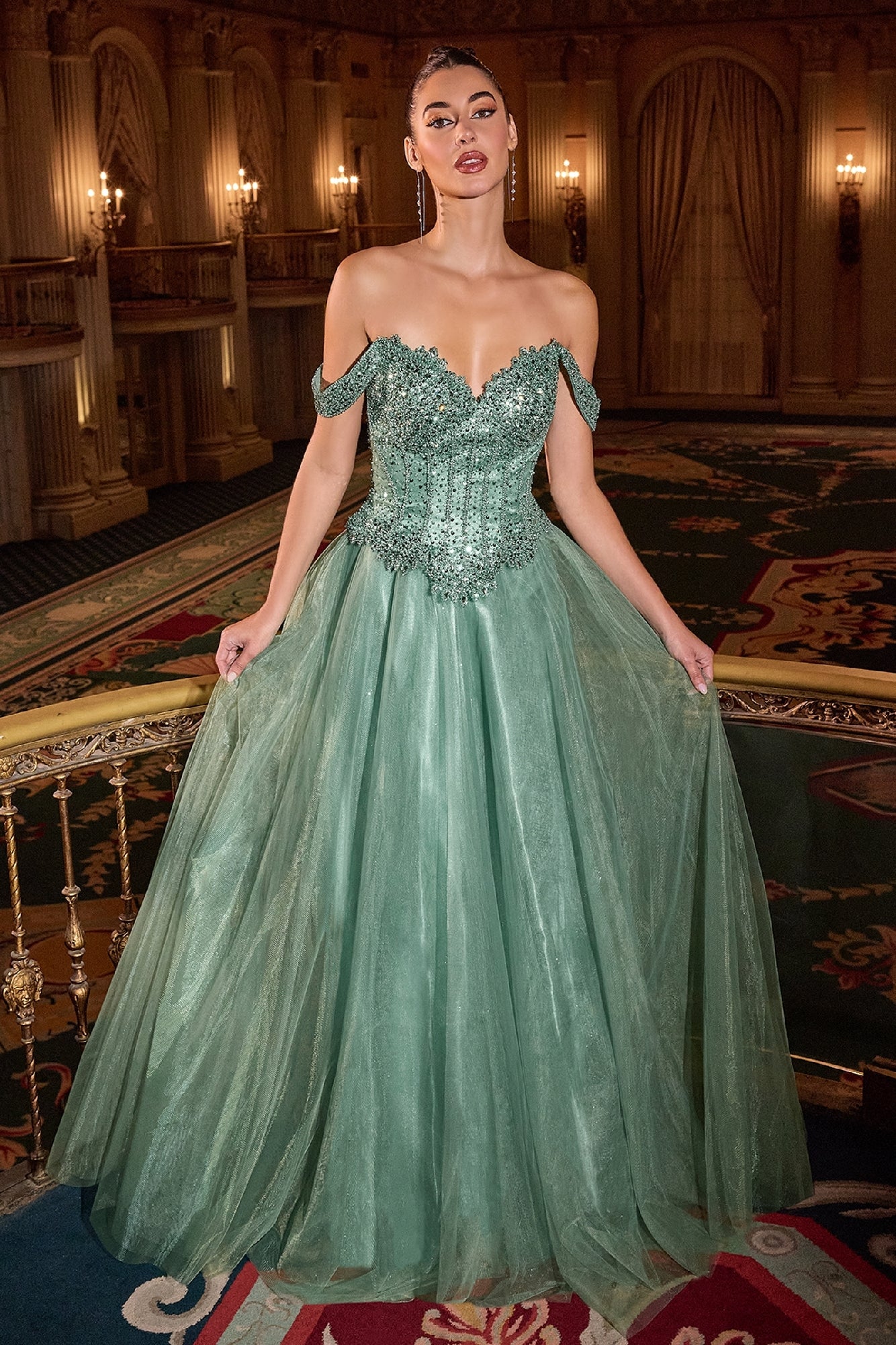Woman in a green evening gown standing in an opulent room with ornate decor.