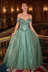 Woman in a green evening gown standing in an opulent room with ornate decor.