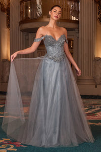Woman in a smoky blue evening gown with a chandelier in the background