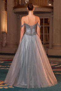 Woman in a glitter tulle evening gown with intricate detailing in an elegant indoor setting.