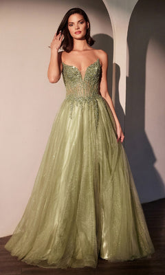 A woman is indoors wearing the Strapless Long Glitter Prom Dress: Ladivine CC487 in light green, featuring a fitted beaded sheer corset bodice and a full tulle A-line skirt.