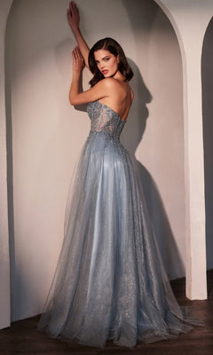 A woman stands with her back to the camera, touching an archway and glancing over her shoulder in the shimmering Strapless Long Glitter Prom Dress: Ladivine CC487, the sparkling blue fabric catching the light.