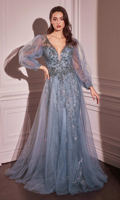 A woman stands in an elegant room wearing the Ladivine CD0102 Sheer-Sleeve Long Prom Dress, a floor-length blue gown featuring floral embellishments, long puffed sleeves, and a deep V-neckline.