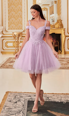 A woman wears the Cold-Shoulder Short Glitter Homecoming Dress CD0132, with lilac lace and tulle, standing in an ornate gold-accented room with a fireplace and chandelier, smiling as she looks to the side.